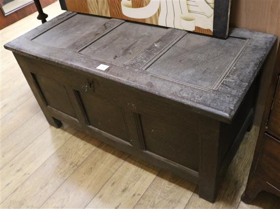 An 18th century three panelled oak coffer, W.115cm